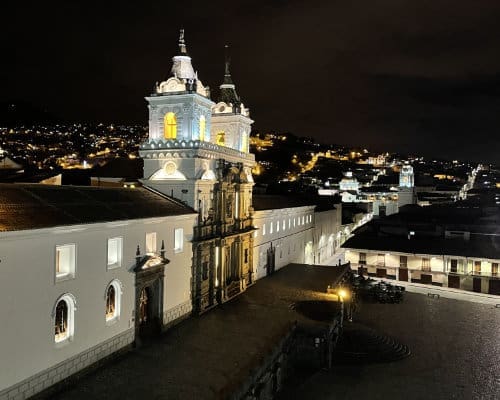 The Iglesia San Francisco brightly lit against a jet black night sky